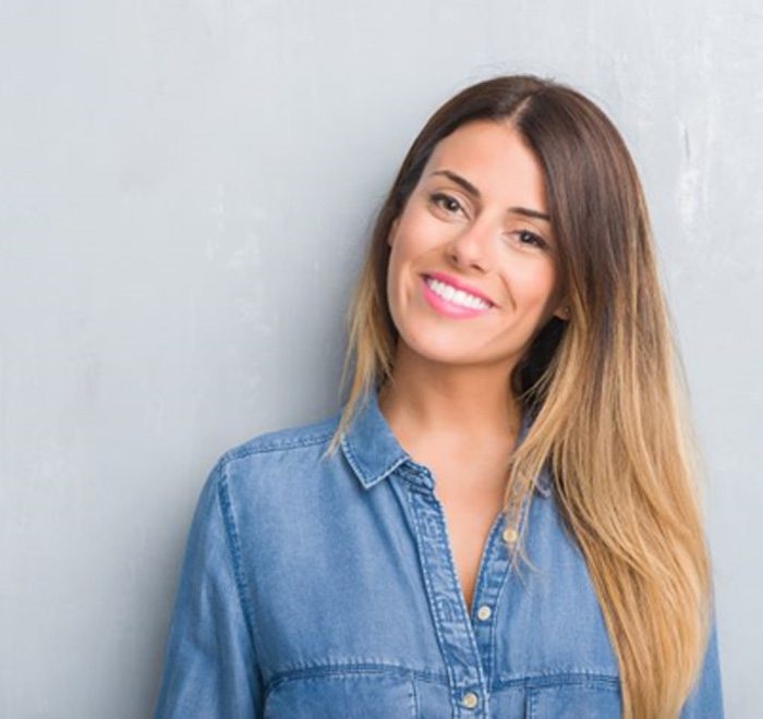 Smiling woman with nice teeth wearing denim shirt