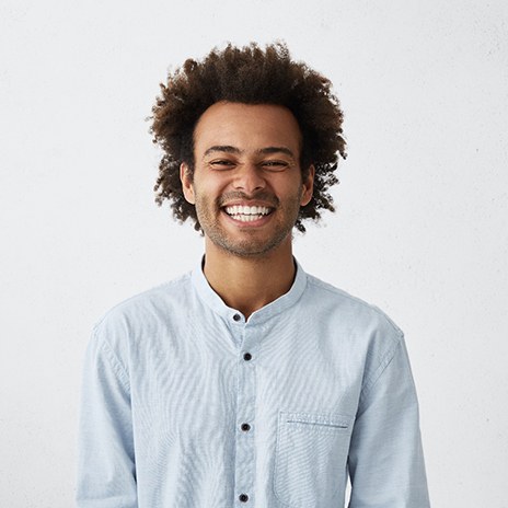 man smiling in front of a white background 